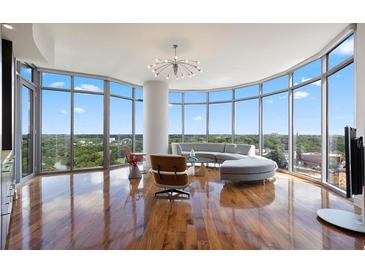 Bright living room features floor-to-ceiling windows and hardwood floors at 222 12Th Ne St # 1806, Atlanta, GA 30309