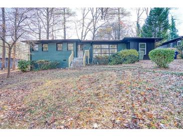 Charming single-story home with a brick exterior and beautifully landscaped front yard at 1760 Detroit Nw Ave, Atlanta, GA 30314