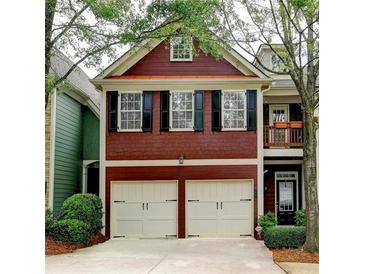 Charming two-story home with red siding, black shutters, and a two-car garage at 2695 Ridge Run Trl, Duluth, GA 30097
