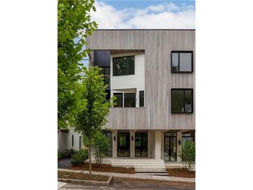 Modern home featuring light wood, black frame windows, and stylish entryway at 11554 Serenbe Ln, Chattahoochee Hills, GA 30268
