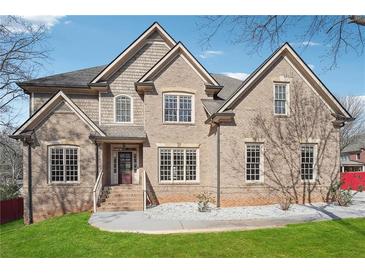 Charming two-story brick home with well-manicured lawn and inviting entrance at 2656 Old Norcross Rd, Tucker, GA 30084