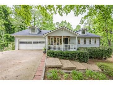 Charming home featuring a stone front porch and attached garage at 2663 Marcia Dr, Lawrenceville, GA 30044