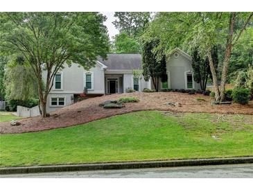 Charming home featuring manicured landscaping and a classic facade, creating inviting curb appeal at 3003 Heavenly Ln, Snellville, GA 30078