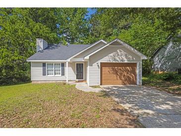 Charming single-story home with vinyl siding, an attached garage, and a well-maintained front yard at 785 Redland Dr, Jonesboro, GA 30238