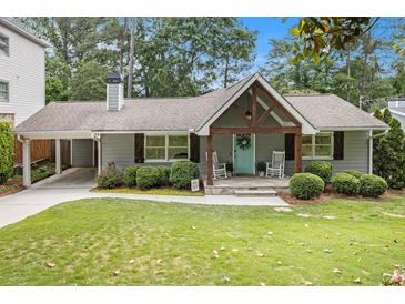 Charming single-story home with a welcoming front porch and beautifully landscaped yard at 3013 Surrey Ln, Atlanta, GA 30341