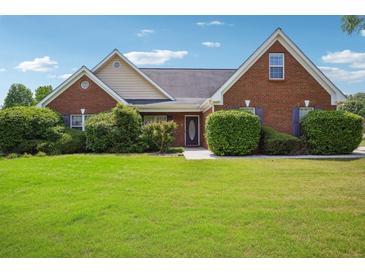 Charming brick home with lush green lawn and manicured bushes in a residential neighborhood at 538 First St, Lawrenceville, GA 30046