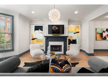 Stylish living room featuring a fireplace, modern lighting, and hardwood floors at 190 Centennial Way, Atlanta, GA 30313