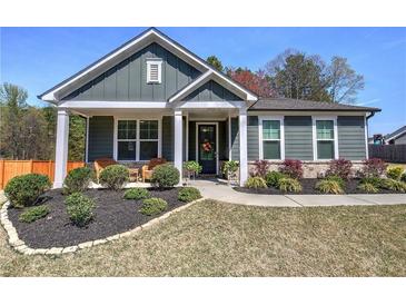 Inviting single story home with manicured lawn, charming front porch, and craftsman details at 34 Mountainbrook Nw Dr, Cartersville, GA 30121