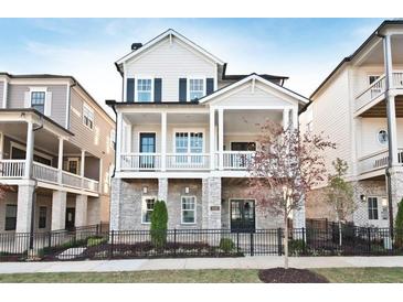 Charming two-story home with stone accents, black shutters, inviting porch, and manicured landscaping at 1419 Coretta Bnd, Atlanta, GA 30318
