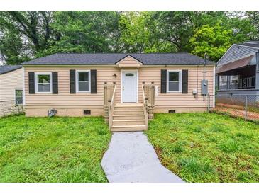 Charming single-story home with tan siding, black shutters, and a well-maintained front yard at 1482 Connally Sw Ave, Atlanta, GA 30310