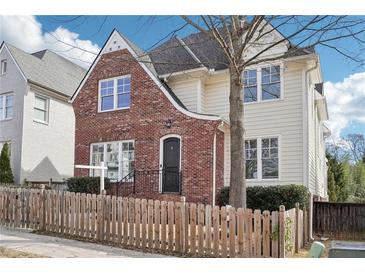 Charming two-story home featuring a unique brick facade and a well-maintained fenced front yard at 2685 Grady Se St, Smyrna, GA 30080