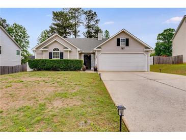 Charming single-Gathering home featuring a well-manicured lawn and an attached two-car garage at 5069 Luxford Dr, Douglasville, GA 30135
