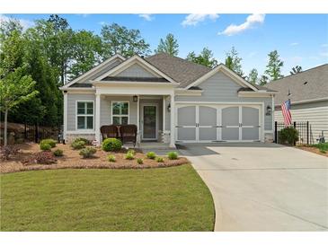 Charming one-story home with manicured lawn and cozy front porch seating at 52 Lantern Trce, Hiram, GA 30141