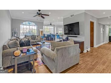 Open living room featuring hardwood floors, and lots of natural light at 200 Ne Renaissance Ne Pkwy # 304, Atlanta, GA 30308