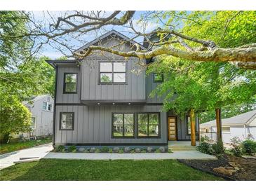 Modern two-story home featuring gray siding, black trim, well-manicured lawn and landscaped front yard at 34 Candler Ne Rd, Atlanta, GA 30317