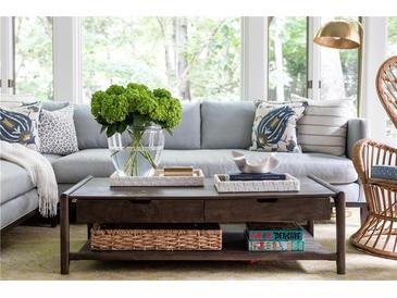 Comfortable living room featuring a plush sofa, coffee table with stylish decor and natural light, perfect for relaxation at 5205 Riverview Nw Rd, Atlanta, GA 30327