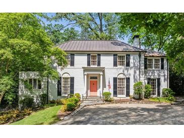 Elegant white brick home features black shutters, a copper roof, and manicured landscaping at 3086 E Pine Valley Nw Rd, Atlanta, GA 30305