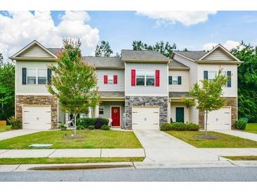 Charming townhomes with manicured lawns, stone accents, and individual driveways, located in a Gathering-friendly neighborhood at 692 Oakside Pl, Acworth, GA 30102