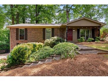 Charming brick home featuring lush landscaping and inviting front entrance at 3517 Greenway Dr, Marietta, GA 30008