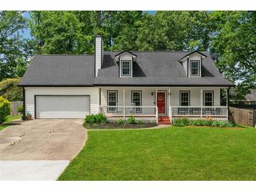 Charming home featuring a red front door, front porch and manicured front lawn at 831 Terrace Trce, Lawrenceville, GA 30044