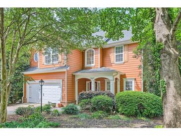 Charming two-story home with manicured landscaping, a welcoming front porch and a two car garage at 1259 Crescentwood Ln, Decatur, GA 30032