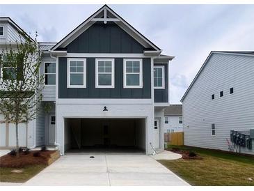 Two-story home featuring a painted brick front with an attached two car garage at 1956 Asher Ln # 51, Conyers, GA 30013