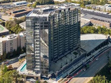 Stunning high-rise building featuring modern glass architecture, a pool, and a convenient parking deck at 788 W Marietta Nw St # 905, Atlanta, GA 30318