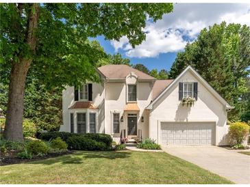 Charming two-story traditional home featuring an attached garage, manicured lawn, and mature trees in a desirable neighborhood at 988 Gentry Sw Ln, Marietta, GA 30064