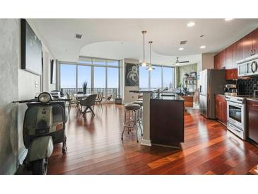 Bright, open kitchen and dining area with cherry wood floors and stainless appliances at 400 W Peachtree Nw St # 3801, Atlanta, GA 30308
