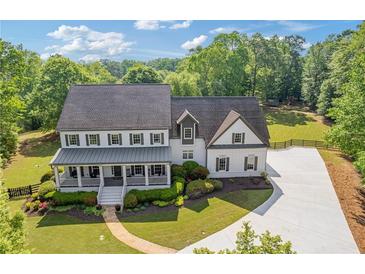 Stunning two-story home featuring a charming front porch and lush landscaping at 110 Hawks Bnd, Canton, GA 30115