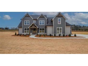 Charming home featuring a gray exterior, landscaped yard, and inviting entryway at 180 Paislee Park (Lot #9 Paislee Park) Dr, Fayetteville, GA 30215