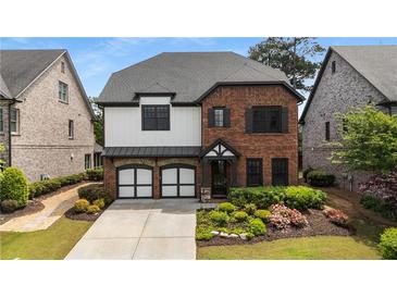 Beautiful two-story home with brick accents, two-car garage, and manicured landscaping at 4900 Kentwood Dr, Marietta, GA 30068