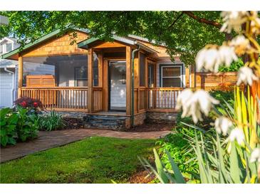 Charming home featuring a welcoming porch, complemented by lush landscaping and a brick pathway leading to the entrance at 625 Kennesaw Ave, Atlanta, GA 30308