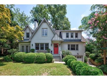Charming two-story home with a red door, mature trees and manicured landscaping at 509 Ponce De Leon Pl, Decatur, GA 30030