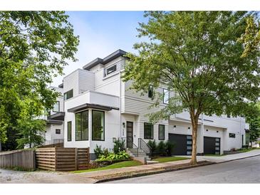 Modern townhome showcasing a sleek design with a two-car garage and manicured landscaping at 520 Wabash Ne Ave, Atlanta, GA 30312