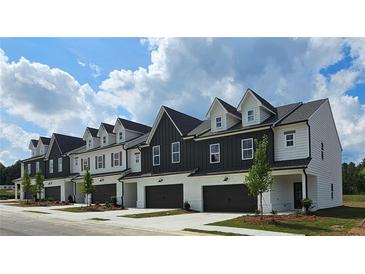 Beautifully designed townhomes featuring private garages, modern architecture and manicured landscaping at 208 Sharon Ln, Loganville, GA 30052