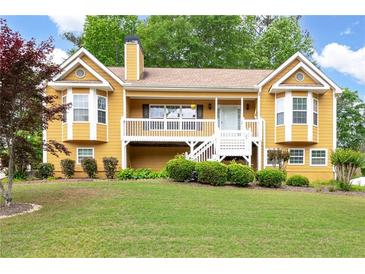 Charming two-story home featuring a welcoming front porch, landscaped yard, and a warm, inviting facade at 55 Cross Pointe Ct, Hiram, GA 30141