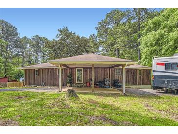 Cozy wooded home with a covered carport and ample parking for an RV or recreational vehicle at 263 Lynn Dr, Fayetteville, GA 30215