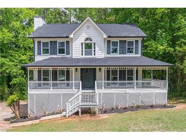 Charming two-story home with a large covered porch and inviting curb appeal at 5139 Coolamber Dr, Powder Springs, GA 30127