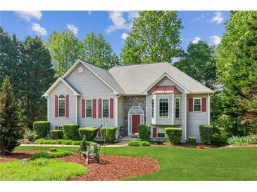 Charming two-story home featuring red shutters, gray siding and a well-manicured lawn at 6990 N Glen Dr, Cumming, GA 30028