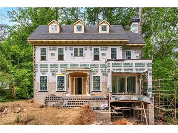 New construction featuring a brick and hardie board exterior with dormers and a covered front entry at 1176 Lullwater Ne Rd, Atlanta, GA 30307