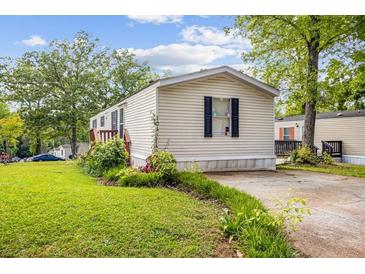 Well-maintained home with a tidy lawn, mature trees and an ample driveway at 101 Olympic Ct, Fayetteville, GA 30214