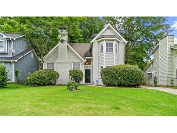 Charming two-story home with a lush green lawn and well-maintained landscaping at 76 Burbank Dr, Atlanta, GA 30314