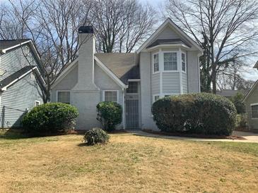 Charming two-story home featuring a well-maintained front yard and brick chimney at 76 Burbank Dr, Atlanta, GA 30314