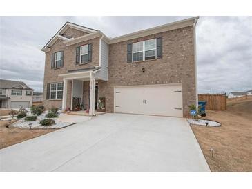 Traditional two-story brick home with a two-car garage and well-maintained landscaping at 2718 Serena Way, Atlanta, GA 30331
