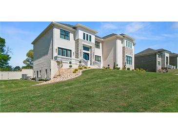 Stately two-story home with a manicured lawn and stone accents at 2989 Waterford Dr, Conyers, GA 30094