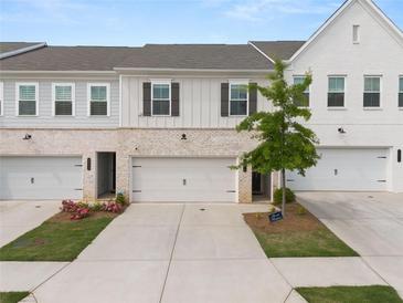 Charming townhomes featuring attached garages and a mix of brick and siding exteriors at 3604 Silvery Way, Powder Springs, GA 30127