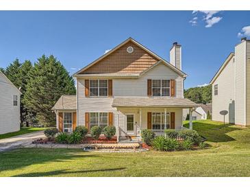 Charming two-story home featuring a well-manicured front lawn and welcoming porch at 982 Hunt Rd, Jonesboro, GA 30236