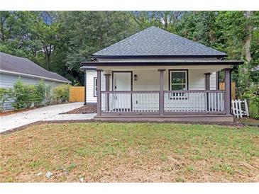 Charming home featuring a cozy front porch and freshly cut lawn at 1055 Mayson Turner Nw Rd, Atlanta, GA 30314