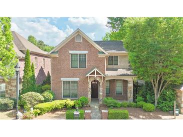 Charming two-story brick home with well-manicured landscaping and inviting entrance, nestled among mature trees at 2080 Village Station Xing, Smyrna, GA 30080